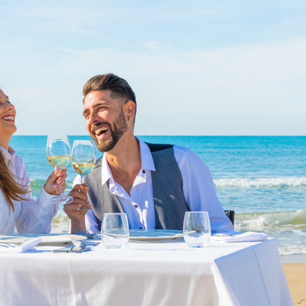 Celebrate. A blissful couple enjoys a romantic beachfront dinner on the picturesque island of Corfu.