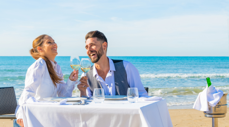 Celebrate. A blissful couple enjoys a romantic beachfront dinner on the picturesque island of Corfu.