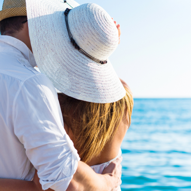 A couple embraces the breathtaking panorama from the terrace of Villa Epavlis, perched on the hills overlooking Komenno Bay in Corfu.