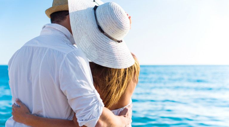 A couple embraces the breathtaking panorama from the terrace of Villa Epavlis, perched on the hills overlooking Komenno Bay in Corfu.